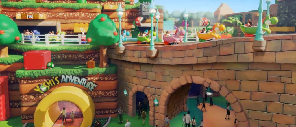 Imagem ilustrativa de como será a nova atração Yoshi's Adventure na nova area Super Nintendo World no parque Epic Universe. É possível ver carrinhos em formato de Yoshis coloridos passeando tranquilamente sobre a land detalhada com árvores com maçãs, power ups, plantas carnívoras tipicas do jogo Super Mario World