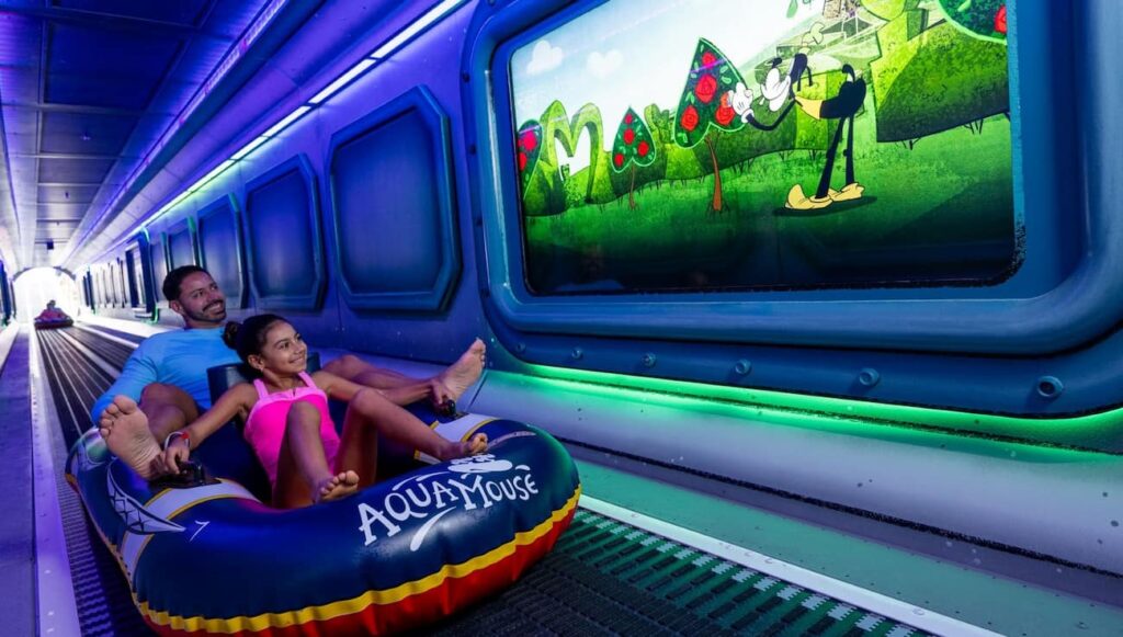tobogã aquático aquamouse com projeções de desenhos dentro do navio Disney Destiny